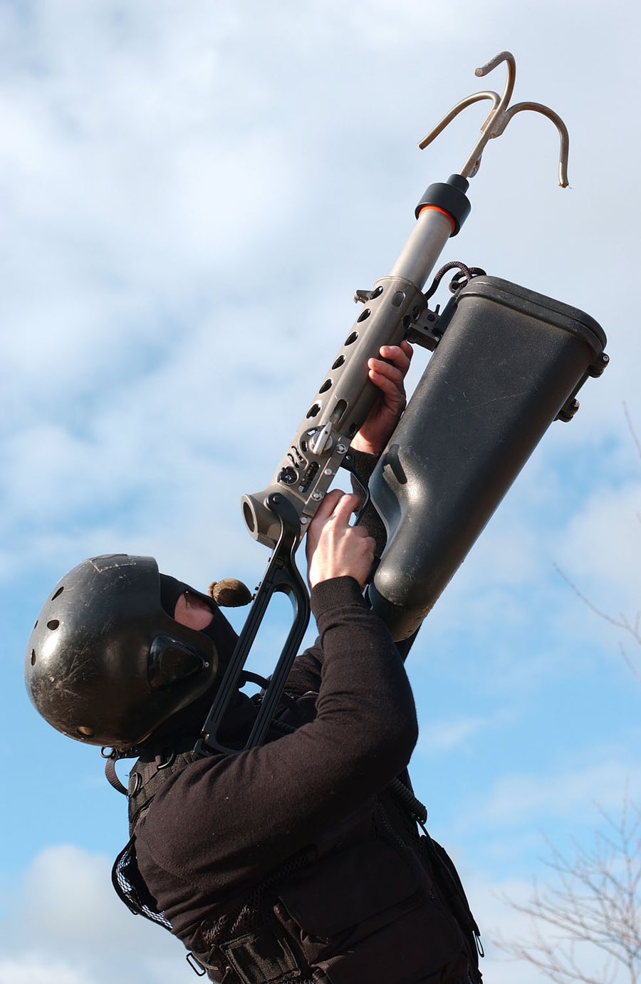Operator aiming an ALM grappling hook straight up
