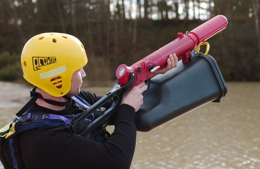 Rescuer aiming a ResQmax across a river