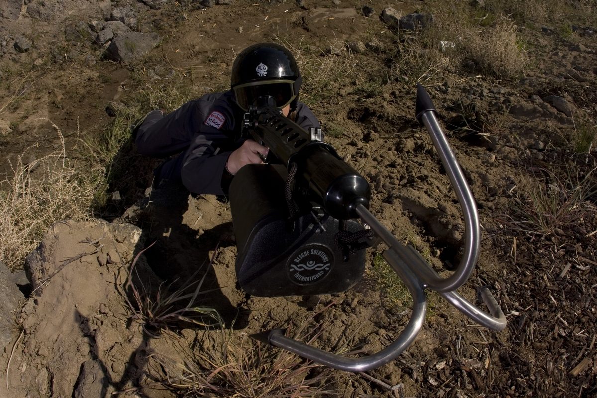 Operator lying prone with a Tactical ResQmax and grappling hook